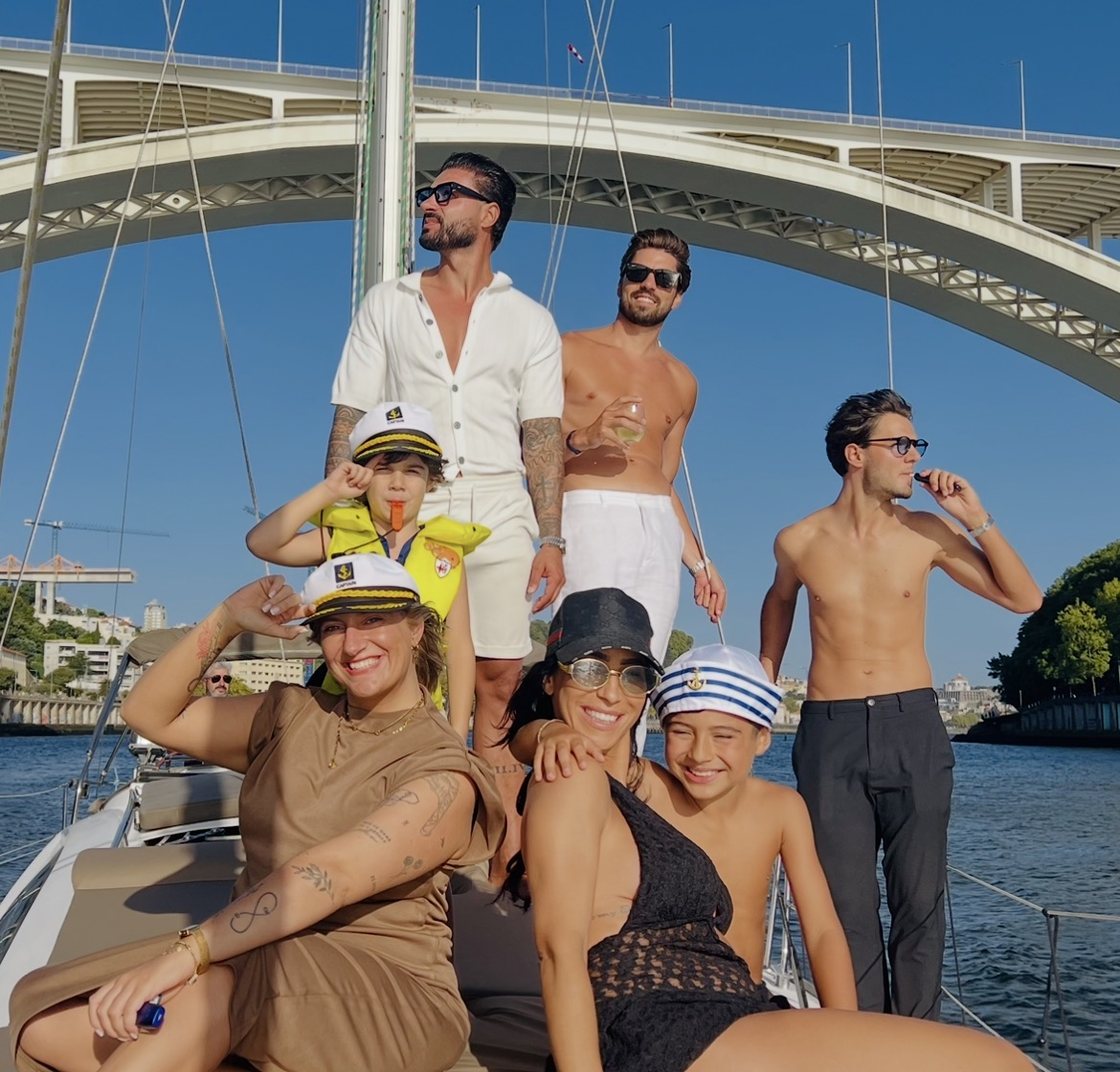 A family together on the deck of a Port Sailors sailboat on the Douro in Porto